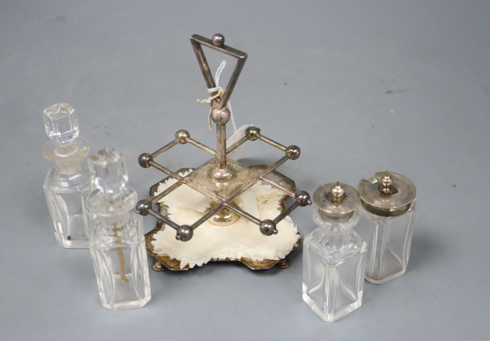 A stylish Victorian silver cruet stand, by Hukin and Heath, Birmingham, 1885, with four matching glass bottles